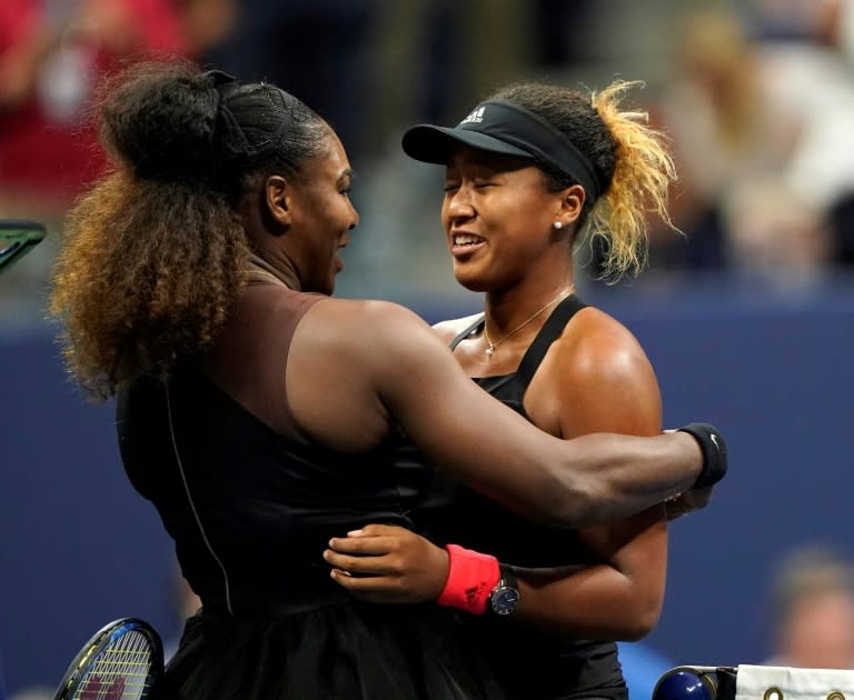 Naomi Osaka of Japan (R) and Serena Williams of the US meet at the net after their 2018 US Open women's singles final match in New York