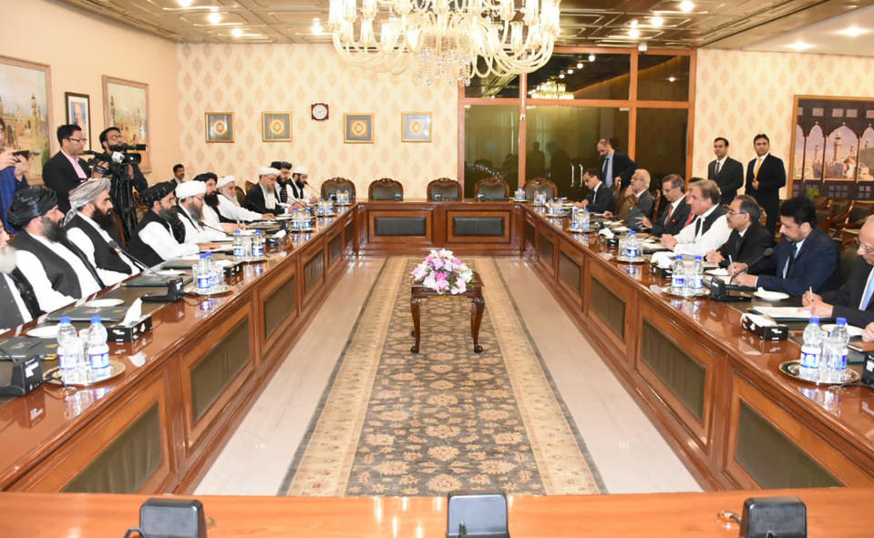 In this photo released by the Foreign Office, Pakistan's Foreign Minister Shah Mehmood Qureshi, fourth from right, heads talks with Taliban delegation at the Foreign Office in Islamabad, Pakistan, Thursday, Oct. 3, 2019. Senior Taliban leaders are meeting with Qureshi in Islamabad as part of a push to revive an Afghanistan peace deal that has included stops in Russia, China and Iran. (Pakistan Foreign Office via AP)