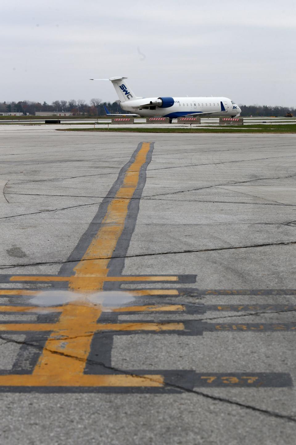 The older asphalt tarmac can see cracks during a multi-year tarmac and ramp replacement project Wednesday, Nov. 8, 2023, at the South Bend International Airport.