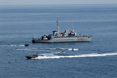 An Italian Navy vessel, Italian Police on sea scooters and Coast Guard patrol on the sea in front of Taormina, Italy, May 23, 2017. REUTERS/Antonio Parrinello