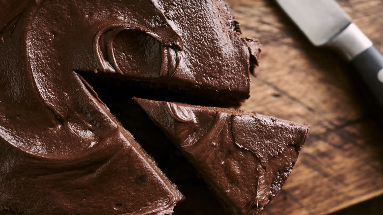 chocolate cake on a wooden cutting board