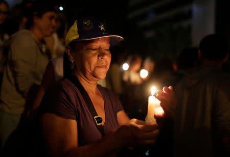 Opposition supporters hold candles while participating in a candlelight rally against President Nicolas Maduro in Caracas, Venezuela, May 17, 2017. REUTERS/Marco Bello