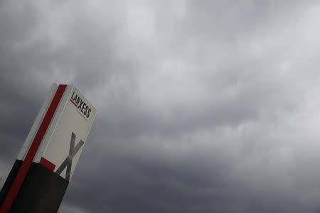 A logo of Lanxess is seen next to dark clouds at Cologne Bonn airport March 27, 2015. REUTERS/Wolfgang Rattay