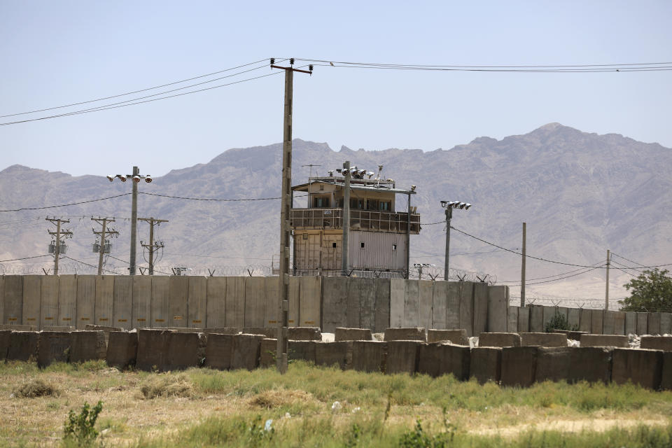 FILE - In this June 25, 2021, file photo a wall surrounds Bagram Air Base in Afghanistan. In 2001 the armies of the world united behind America and Bagram Air Base, barely an hours drive from the Afghan capital Kabul, was chosen as the epicenter of Operation Enduring Freedom, as the assault on the Taliban rulers was dubbed. It's now nearly 20 years later and the last US soldier is soon to depart the base. (AP Photo/Rahmat Gul, File)