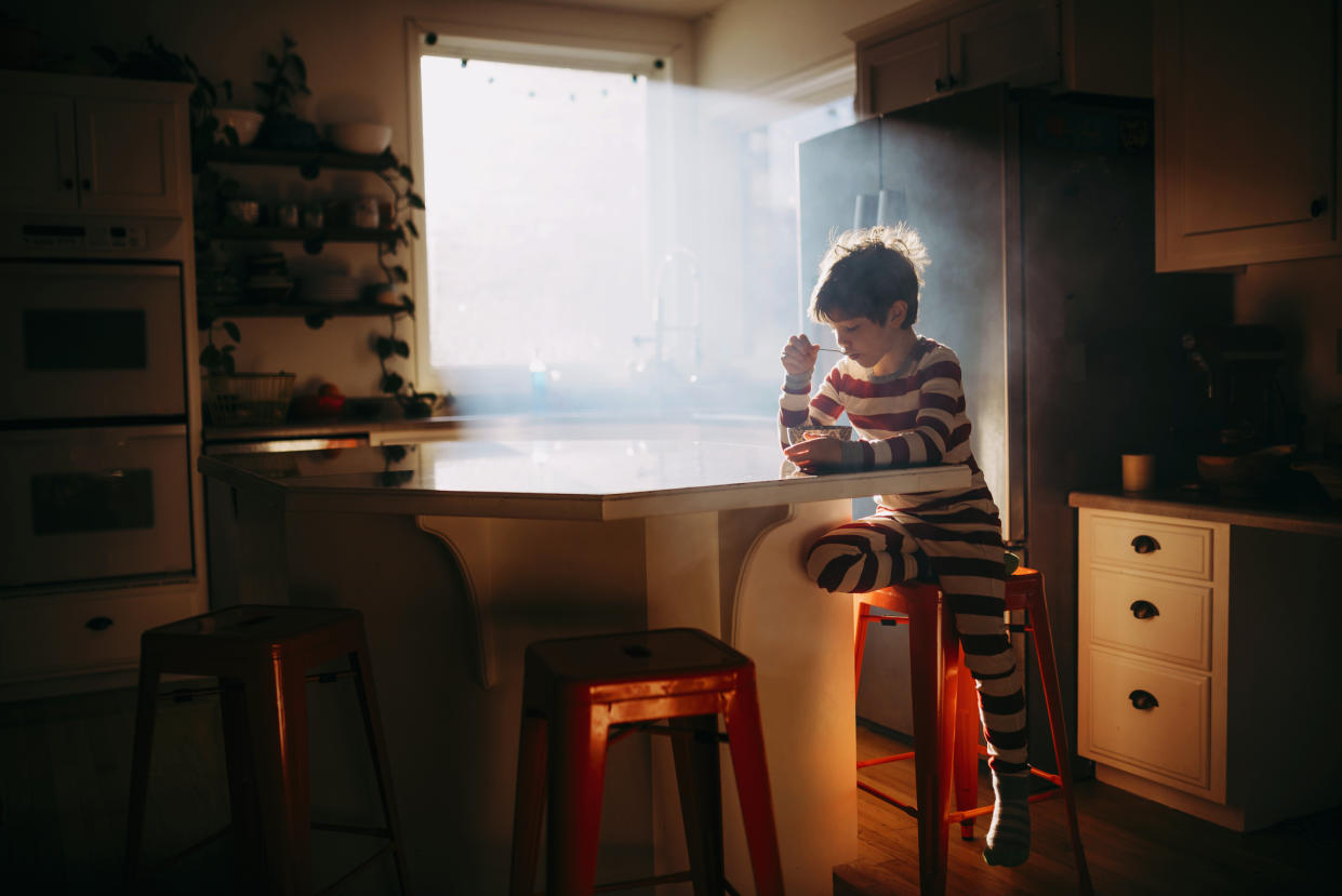 Boy alone eating breakfast. (Getty Images)