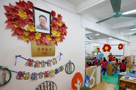 Vietnamese children play in front of a portrait of late North Korea's leader Kim Il at the Vietnam-North Korea Friendship kindergarten, founded by North Korean Government in 1978 in Hanoi, Vietnam February 13, 2019. REUTERS/Kham