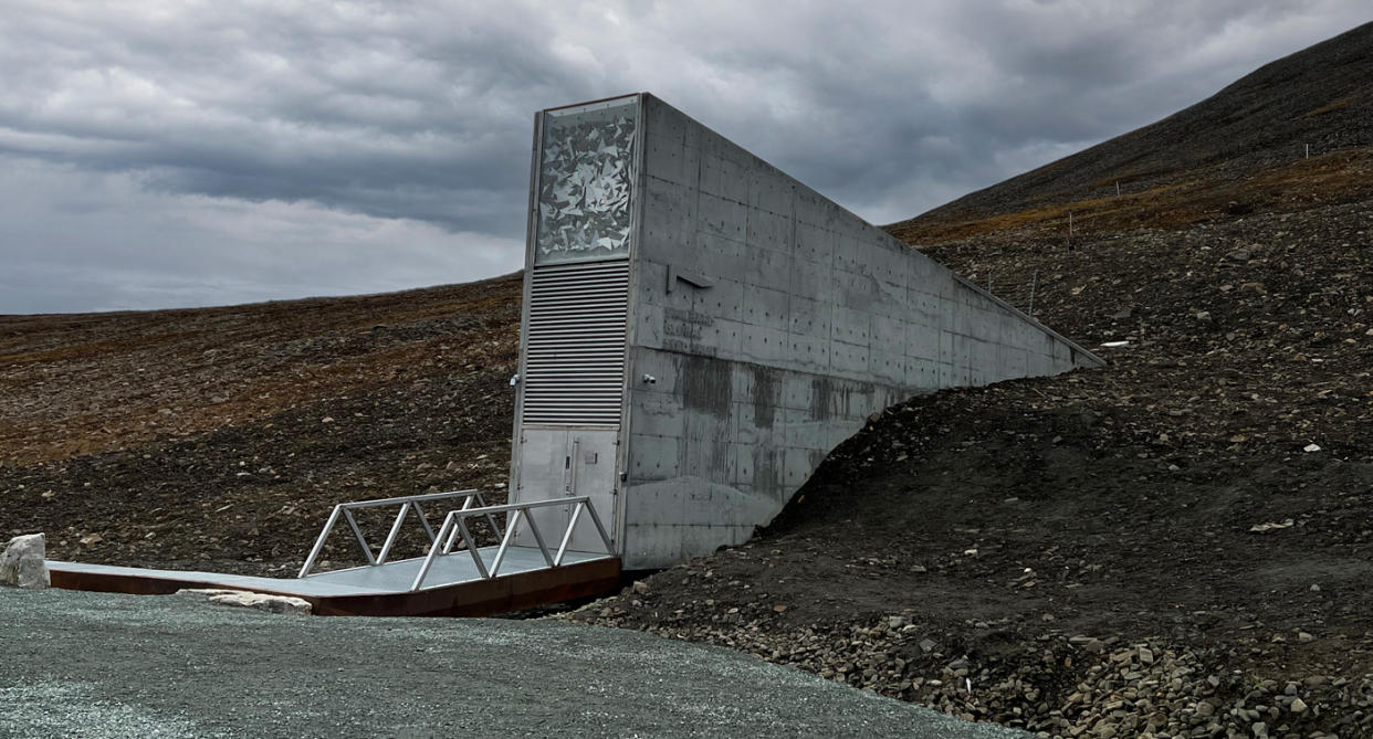 Grey vault entrance juts out from hillside in Norway.