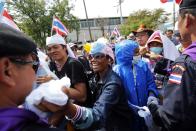 Policemen and anti-government protesters great each other inside the compound of metropolitan police headquarters, the site of fierce clashes over the last few days, in Bangkok December 3, 2013. Thailand's government ordered police to stand down and allow protesters into state buildings on Tuesday, removing a flashpoint for clashes and effectively bringing an end to days of violence in Bangkok in which five people have died. REUTERS/Damir Sagolj (THAILAND - Tags: CIVIL UNREST POLITICS CRIME LAW)