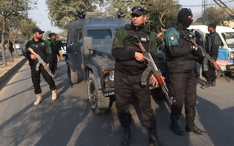 Pakistani policemen escort an armoured vehicle carrying serial killer Mohammad Imran to court - Credit:  ARIF ALI/AFP