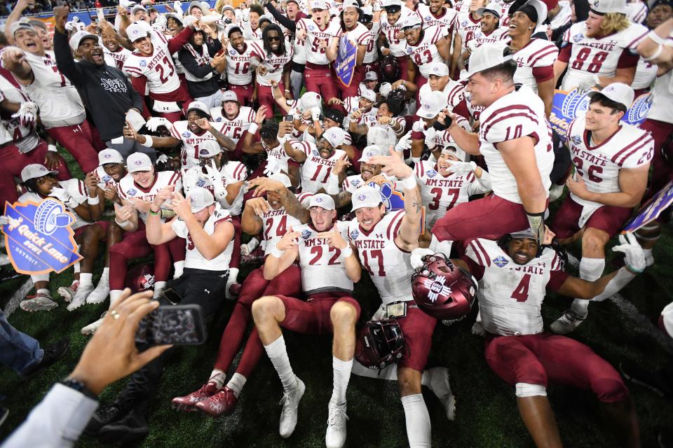 New Mexico State players celebrate after the 24-19 win over Bowling Green in the Quick Lane Bowl on Monday, Dec. 26, 2022, at Ford Field.