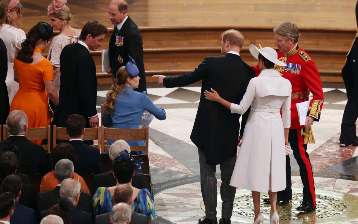 The Duke and Duchess of Sussex are guided to their seats at St Paul's – behind the senior royals - Dan Kitwood/PA Wire
