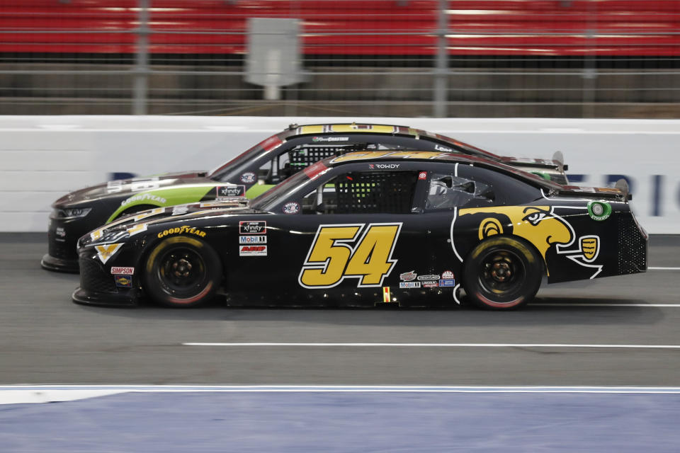 Kyle Busch (54) and Ross Chastain (10) battle during a NASCAR Xfinity Series auto race at Charlotte Motor Speedway Monday, May 25, 2020, in Concord, N.C. (AP Photo/Gerry Broome)