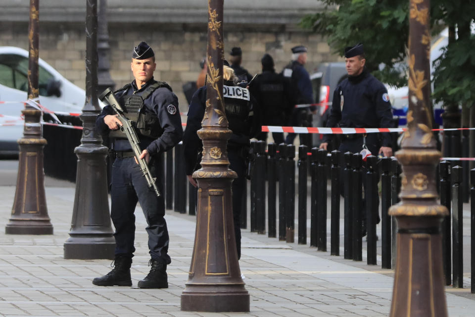 Police officers control the perimeter outside the Paris police headquarters, Thursday, Oct.3, 2019 in Paris. An administrator armed with a knife attacked officers inside Paris police headquarters Thursday, killing at least four before he was fatally shot, officials said. (AP Photo/Michel Euler)