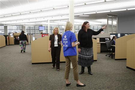 Workers at Covered California's Concord call center talk to each other during the opening day of enrollment of the Patient Protection and Affordable Care Act in Concord, California October 1, 2013. REUTERS/Stephen Lam