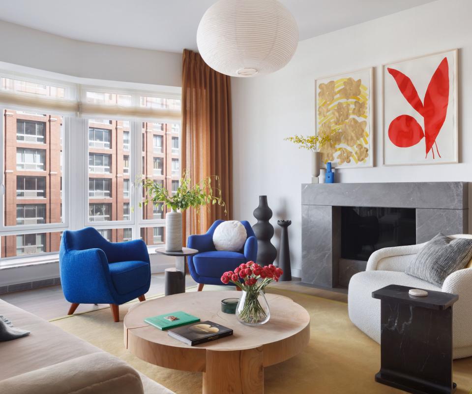 Blue arm chairs, wooden coffee table, orange curtain