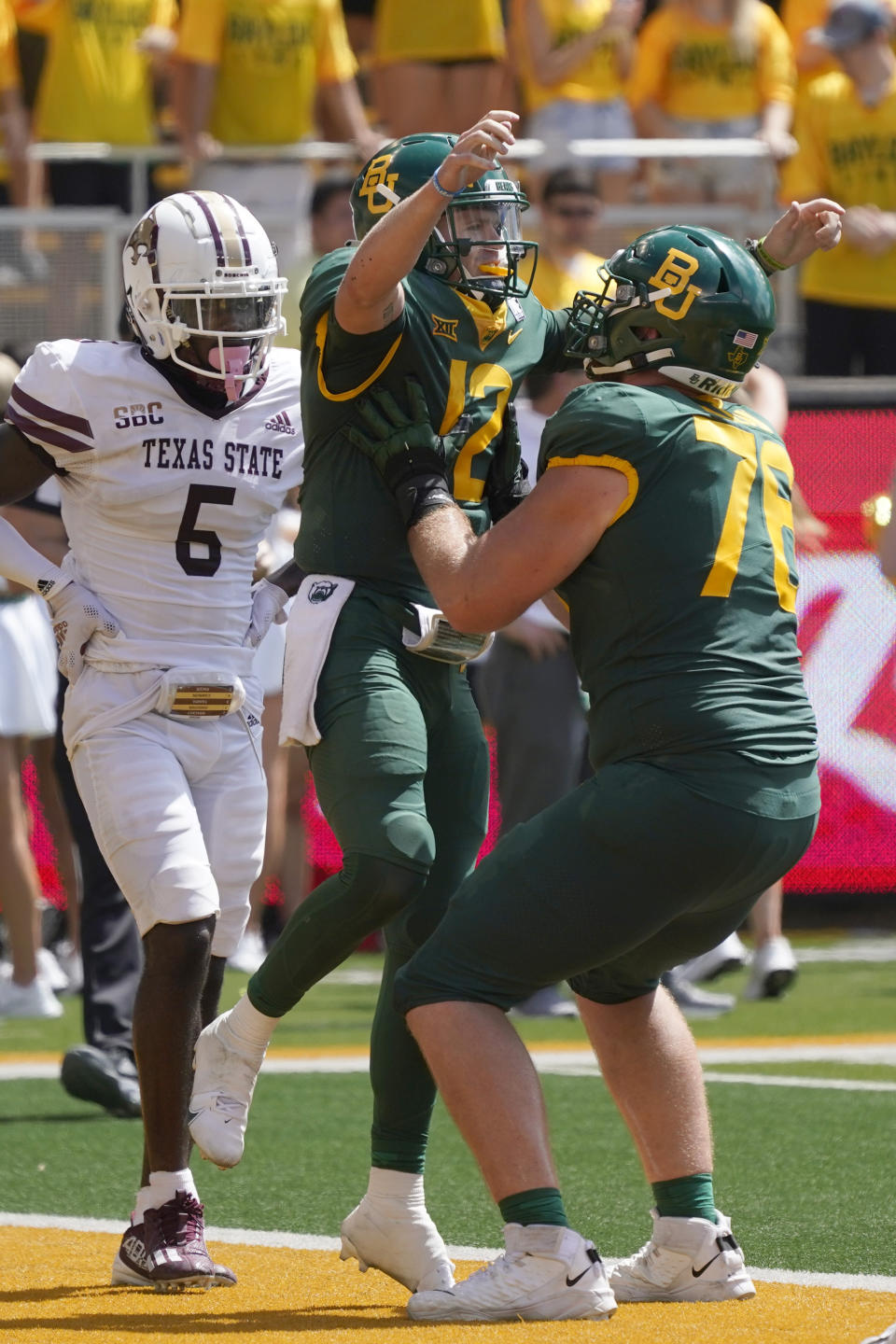 Baylor quarterback Blake Shapen (12) celebrates his touchdown with teammate lineman Connor Galvin (76) as Texas State safety DeJordan Mask (5) looks on during the first half of an NCAA college football game in Waco, Texas, Saturday, Sept. 17, 2022. (AP Photo/LM Otero)