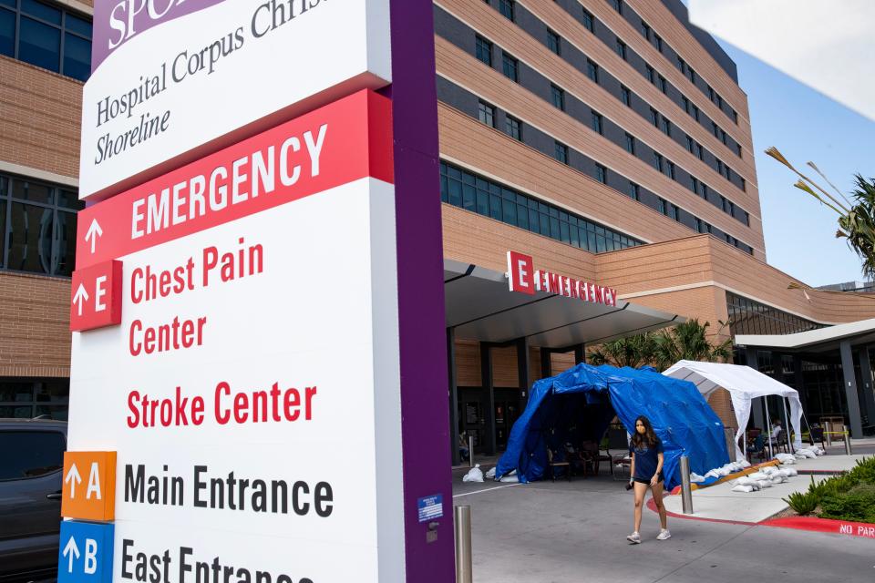 People wait under tents setup outside the emergency room at Christus Spohn Shoreline Hospital on Thursday, July 9, 2020.