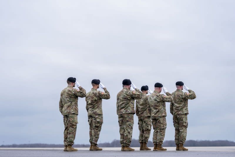 A U.S. Army carry team salutes as the transfer vehicle carrying the remains of Army Sgt. Kennedy Sanders, Army Sgt. William Rivers and Army Sgt. Breonna Moffett prepares to depart during a dignified transfer at Dover Air Force Base in Dover, Del., on Friday. Photo by Bonnie Cash/UPI