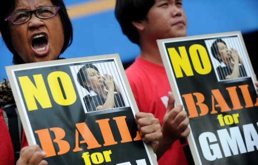 Activists protest outside the court in Pasay City against former Philippine president Gloria Macapagal Arroyo being granted bail. Arroyo was arrested in November, 2011 less than five months after stepping down from nearly 10 years in power and now awaited trial on two separates charges of vote rigging and corruption