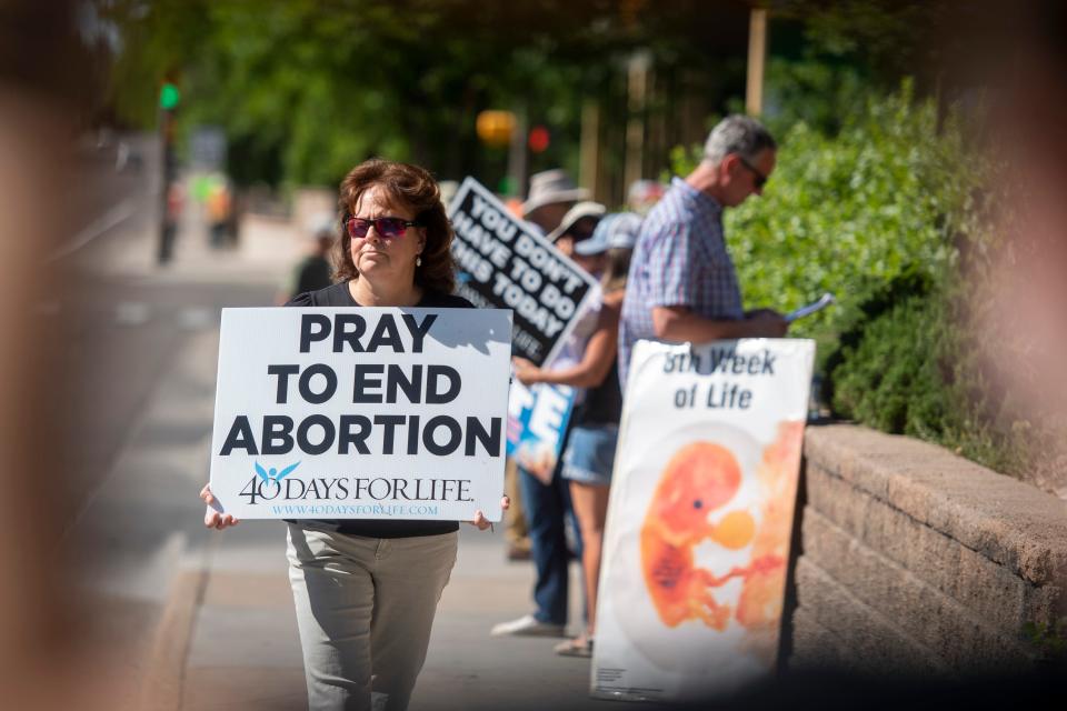Kelly Krapes, of Fort Collins, pickets in front of Planned Parenthood's Fort Collins Health Center on Friday.