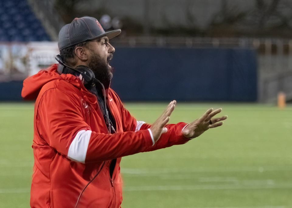 McKinley head coach Antonio Hall shouts to an official during a playoff win last week over St. Ignatius.