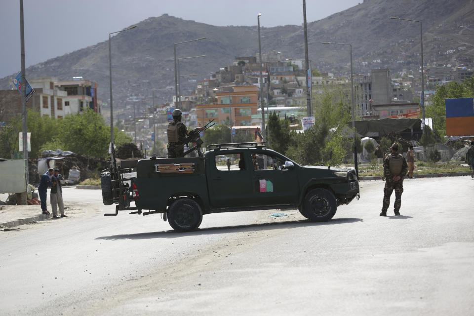 Afghan security forces inspect the site of a bomb explosion in Kabul, Afghanistan, Monday, May 18, 2020. A suicide bomber in a stolen military Humvee targeted a base in eastern Afghanistan belonging to the country's intelligence service early on Monday, killing many members of the force, Afghan officials said. The Taliban claimed responsibility for the attack. (AP Photo/Rahmat Gul)