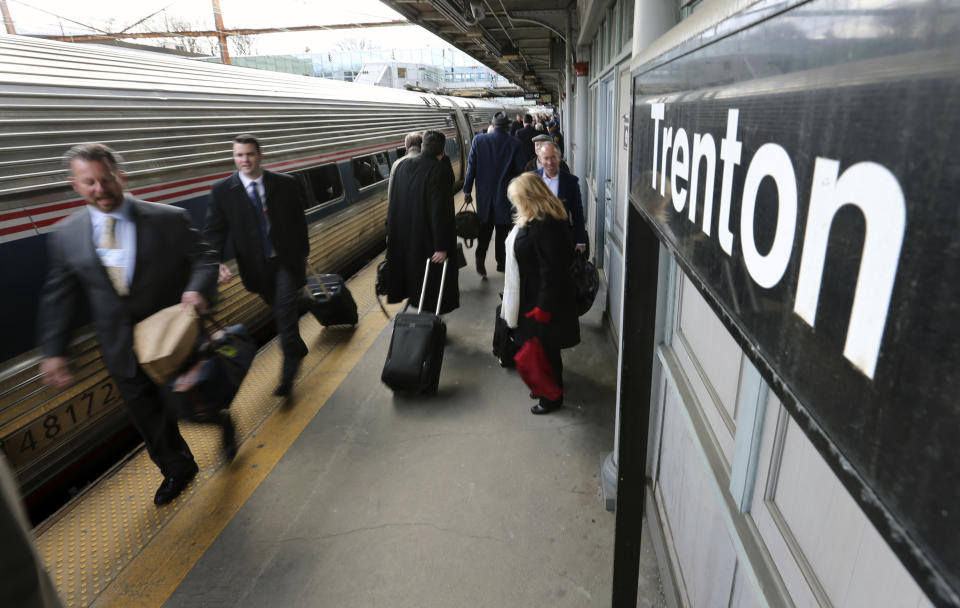 Some of the 1,000 lobbyists, business owners and politicians rush to their assigned cars of the train taking them to Washington, Thursday, Feb. 16, 2017, in Trenton, N.J. The state Chamber of Commerce's 80th annual trip — nicknamed the "Walk to Washington" because rail riders generally pace the train's corridors schmoozing and handing out business cards — comes after a national election that hinged in part on repudiating insiders and establishment politics. (AP Photo/Mel Evans)