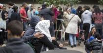 Migrants wait in front of the State Office for Health and Social Affairs (LaGeSo), in Berlin, Germany, September 3, 2015. REUTERS/Hannibal Hanschke