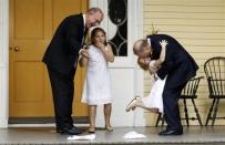 Jonathan Mintz (L), New York City's consumer affairs commissioner, and John Feinblatt (R), a chief adviser to the mayor, embrace their daughters Maeve (2nd L) and Georgia after being married by New York City Mayor Michael Bloomberg at Gracie Mansion in New York July 24, 2011.