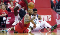 Houston Rockets forward PJ Tucker, left, and Utah Jazz guard Donovan Mitchell, right, scramble for a loose ball during the first half in Game 5 of an NBA basketball playoff series, in Houston, Wednesday, April 24, 2019. (AP Photo/David J. Phillip)