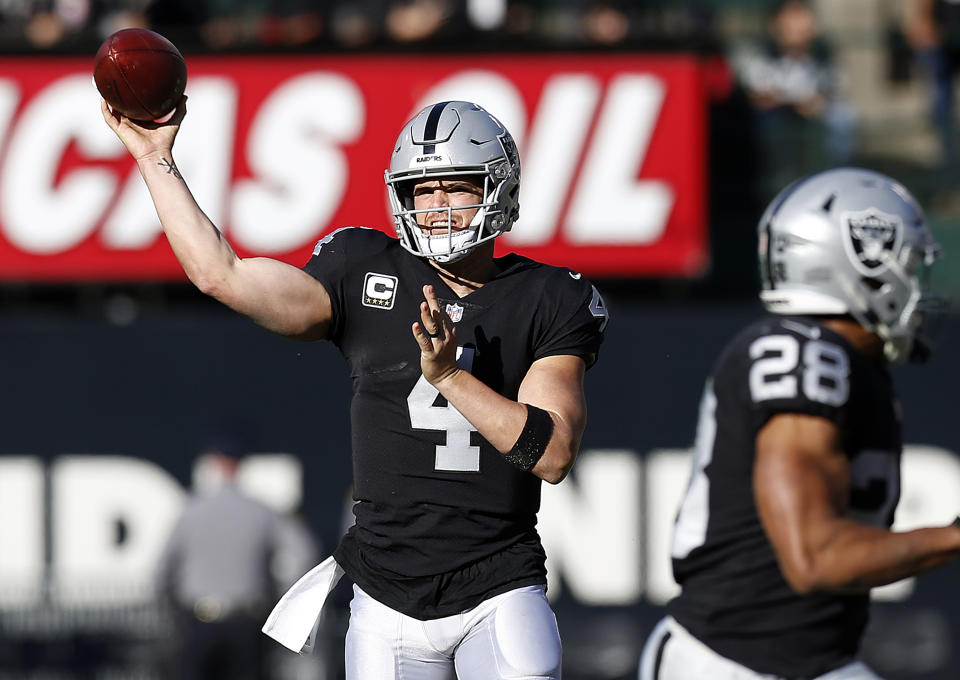 Oakland Raiders quarterback Derek Carr (4) passes against the Kansas City Chiefs during the first half of an NFL football game in Oakland, Calif., Sunday, Dec. 2, 2018. (AP Photo/D. Ross Cameron)