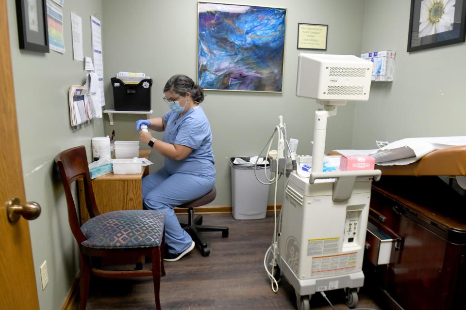 Nurse Kelley Lott prepares medications for the day Friday at Northeast Ohio Women's Center in Cuyahoga Falls.