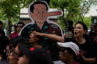 Anti-government protesters gather near a cardboard cut-out mocking Thailand's Prime Minister Prayuth Chan-o-cha as Pinocchio during a protest to demand that the military government hold a general election by November, in Bangkok, Thailand, May 22, 2018. REUTERS/Athit Perawongmetha NO RESALES. NO ARCHIVES.