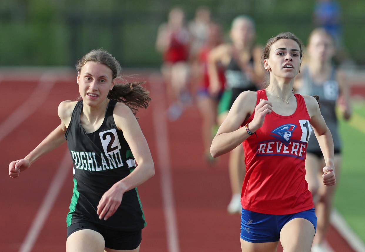 Highland's Katie Schuler races Revere's Keira Lang to the finish line in the 1,600 meters during the Suburban League American Conference track championships at Tallmadge High School on Wednesday, May 8, 2024.