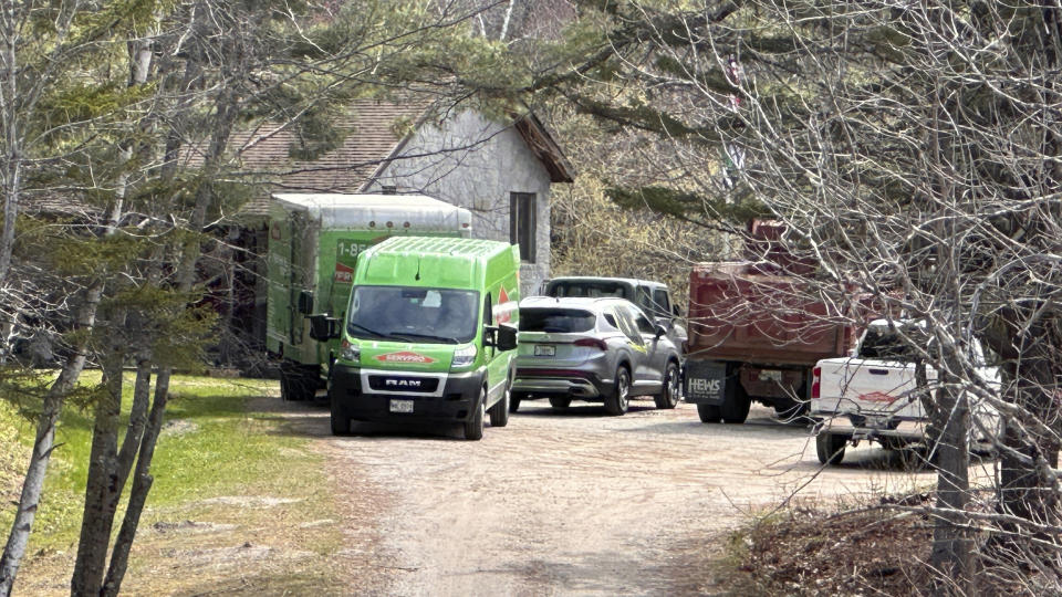 A crime-scene cleaning crew is seen at a home in Bowdoin, Maine, Friday, April 21, 2023, after four people were shot and killed there several days earlier. The deaths shook the area and brought the national spate of mass gunfire home to a rural community where violent crime is rare. (AP Photo/Rodrique Ngowi)