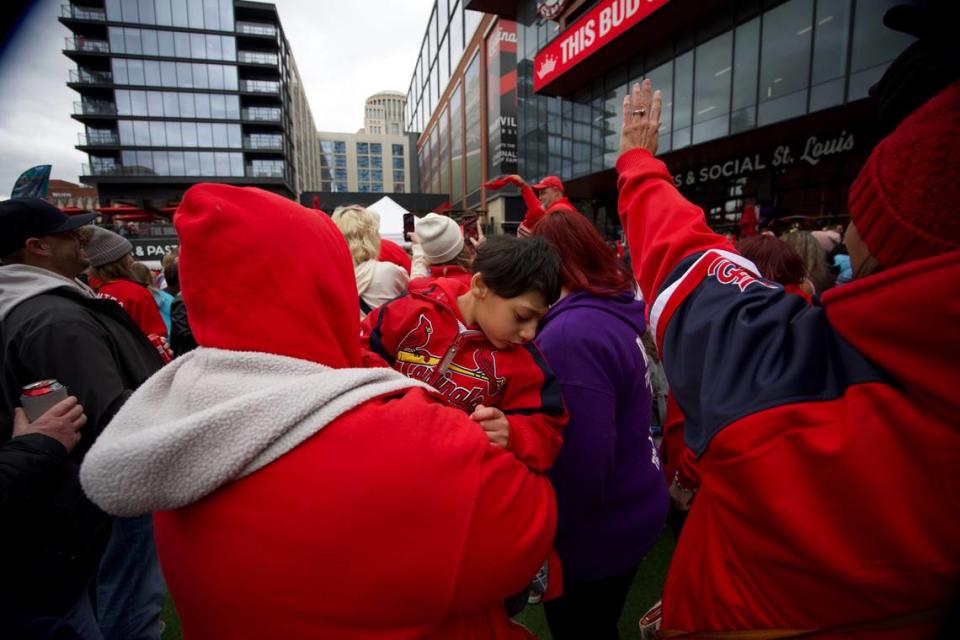 Cardinals fan Robin Anglin of St. Louis holds her son in St. Louis’s Ballpark Village before the Cardinals’ home opener on April 4, 2024. Joshua Carter/Belleville News-Democrat