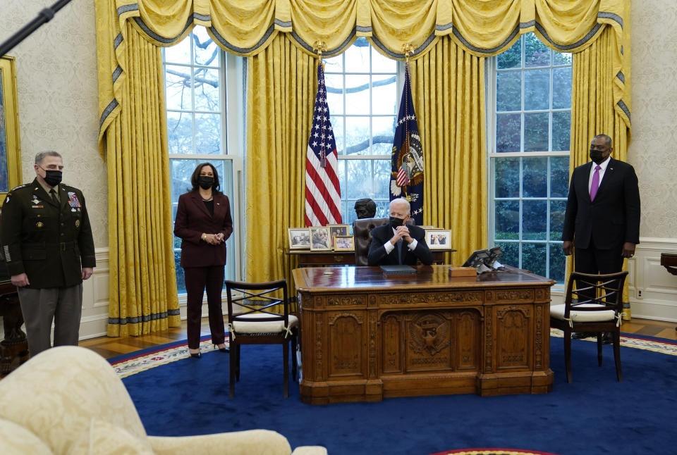 President Joe Biden meets with Secretary of Defense Lloyd Austin, right, Vice President Kamala Harris, and the Chairman of the Joint Chiefs of Staff Mark Milley, left, in the Oval Office of the White House, Monday, Jan. 25, 2021, in Washington. (AP Photo/Evan Vucci)
