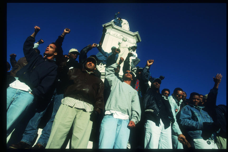 Attendees at the Million Man March raise their fists&nbsp;in Washington, D.C., on Oct. 16, 1995.