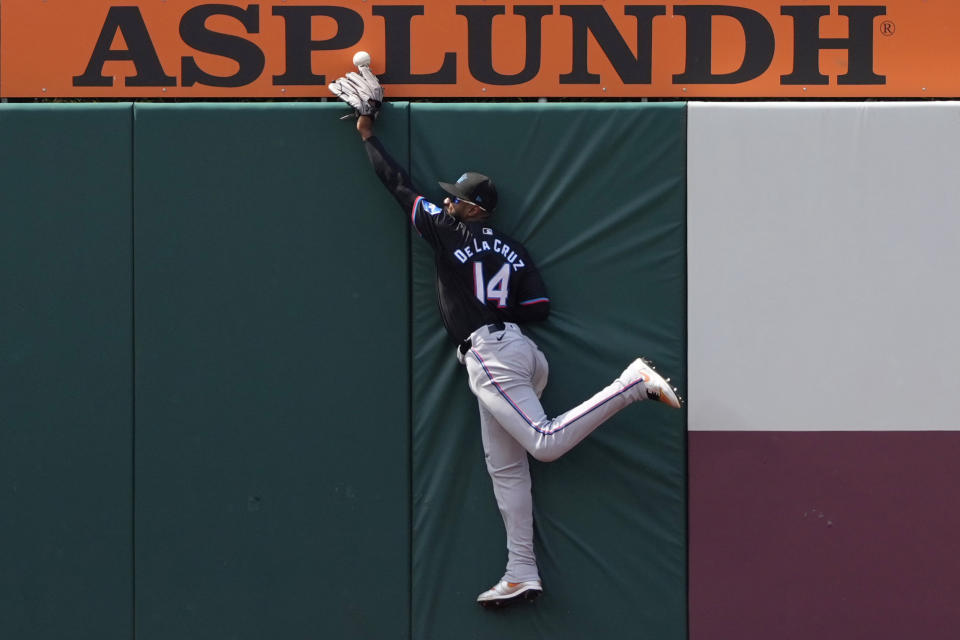 Miami Marlins left fielder Bryan De La Cruz cannot hang on to a run-scoring double by Philadelphia Phillies' Nick Castellanos during the fifth inning of a baseball game, Sunday, June 30, 2024, in Philadelphia. (AP Photo/Matt Slocum)