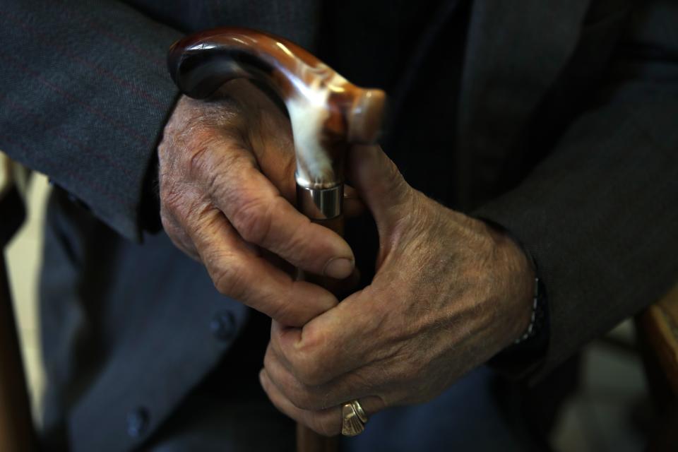 In this Tuesday, May 14, 2019, photo an elderly man holds his walking stick in Karpenisi town at Evrytania region, in central Greece. As balloting for the European Parliament gets underway Thursday and continues through Sunday, voters over 55 are emerging as a powerful bloc on a rapidly aging continent as younger voters stay away from the polls in growing numbers. (AP Photo/Thanassis Stavrakis)