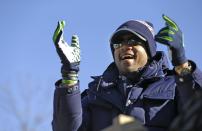 Seattle Seahawks quarterback Russell Wilson applauds fans during a parade for the NFL football Super Bowl champions Wednesday, Feb. 5, 2014, in Seattle. The Seahawks defeated the Denver Broncos 43-8 on Sunday. (AP Photo/Elaine Thompson)