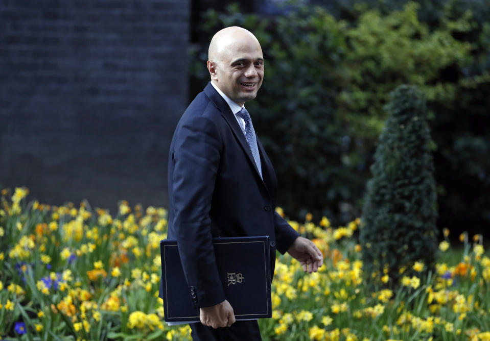 Britain's Home Secretary Sajid Javid smiles as he leaves 10 Downing Street in London after a cabinet meeting, Tuesday, April 2, 2019. Political chaos continued to reign as the Cabinet held a marathon session to try to find a way out of the crisis. A group of pro-Brexit ministers pressed British Prime Minister Theresa May to go forward with a no-deal departure. Other Cabinet members and a majority of lawmakers think that would be a disaster. (AP Photo/Alastair Grant)