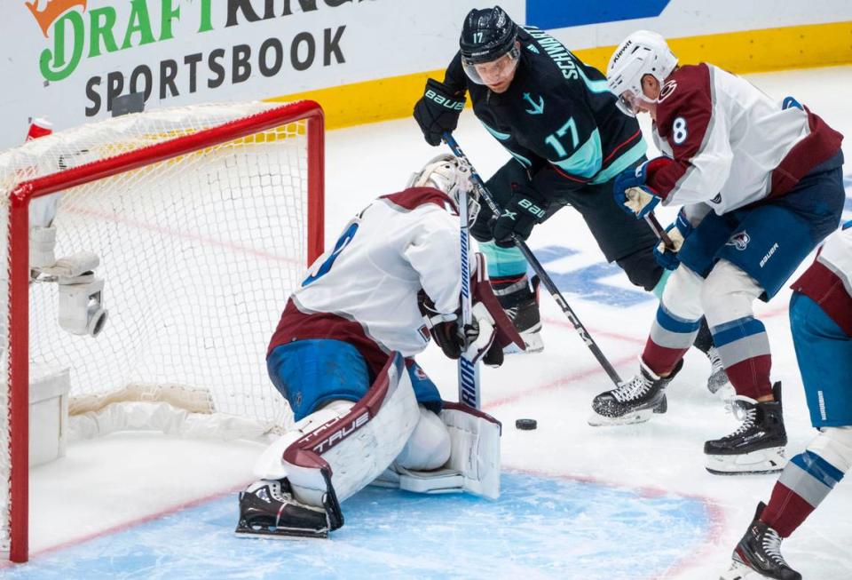 Seattle Kraken center Jaden Schwartz (17) tries to shoot the puck as Colorado Avalanche defenseman Cale Makar (8) defends in overtime of a first round 2023 Stanley Cup Playoffs game against the Colorado Avalanches at Climate Pledge Arena in Seattle on Monday, April 24, 2023.