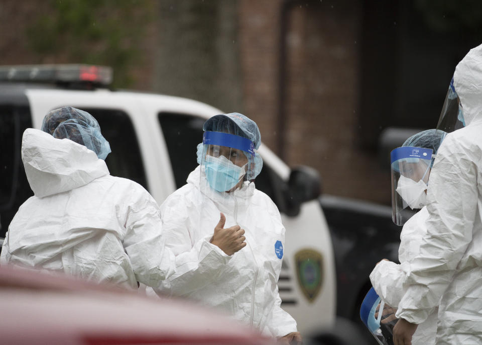 Emergency personnel don PPE before entering the home where more than 90 undocumented immigrants were found on the 12200 block of Chessington Drive, Friday, April 30, 2021, in Houston. A Houston Police official said the case will be handled by federal authorities and that some of the people inside the house were exhibiting COVID-19 symptoms. ( Godofredo A. Vásquez/Houston Chronicle via AP)