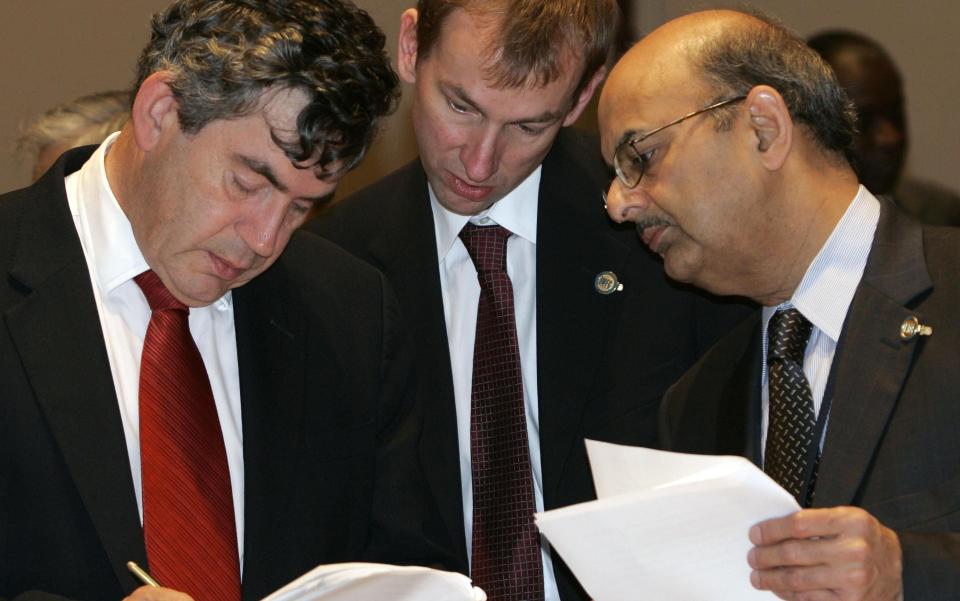 Sir Tom (centre) with Gordon Brown and Shailendra Anjaria at an IMF meeting in 2004 - Getty Images