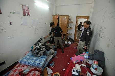 Police search the dorm room of Mashal Khan, accused of blasphemy, who was killed by a mob at Abdul Wali Khan University in Mardan, Pakistan April 14, 2017. REUTERS/Fayaz Aziz