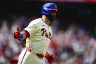 Philadelphia Phillies' Kyle Schwarber gestures after hitting a solo home run off Atlanta Braves starting pitcher Chris Sale during the first inning of a baseball game, Sunday, March 31, 2024, in Philadelphia. (AP Photo/Derik Hamilton)