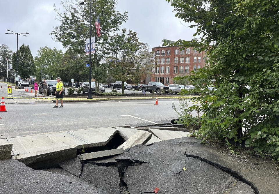 Roads and sidewalks are damaged following heavy rain in Leominster, Mass., Tuesday, Sept. 12, 2023. The deluge flooded other parts of Massachusetts as well as Rhode Island. (AP Photo/Michael Casey)