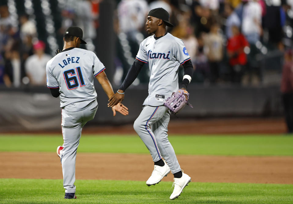 Miami Marlins Otto Lopez (61) and Nick Gordon celebrate after defeating the New York Mets 4-2, Tuesday, June 11, 2024, in New York. (AP Photo/Noah K. Murray)