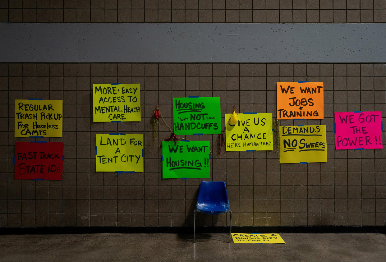 Signs at a temporary center for homeless people run by Kansas City, Mo., on Feb. 11. Cities and community groups are wrestling with how to shelter a vulnerable population without exposing it to an airborne virus that spreads most easily indoors.
